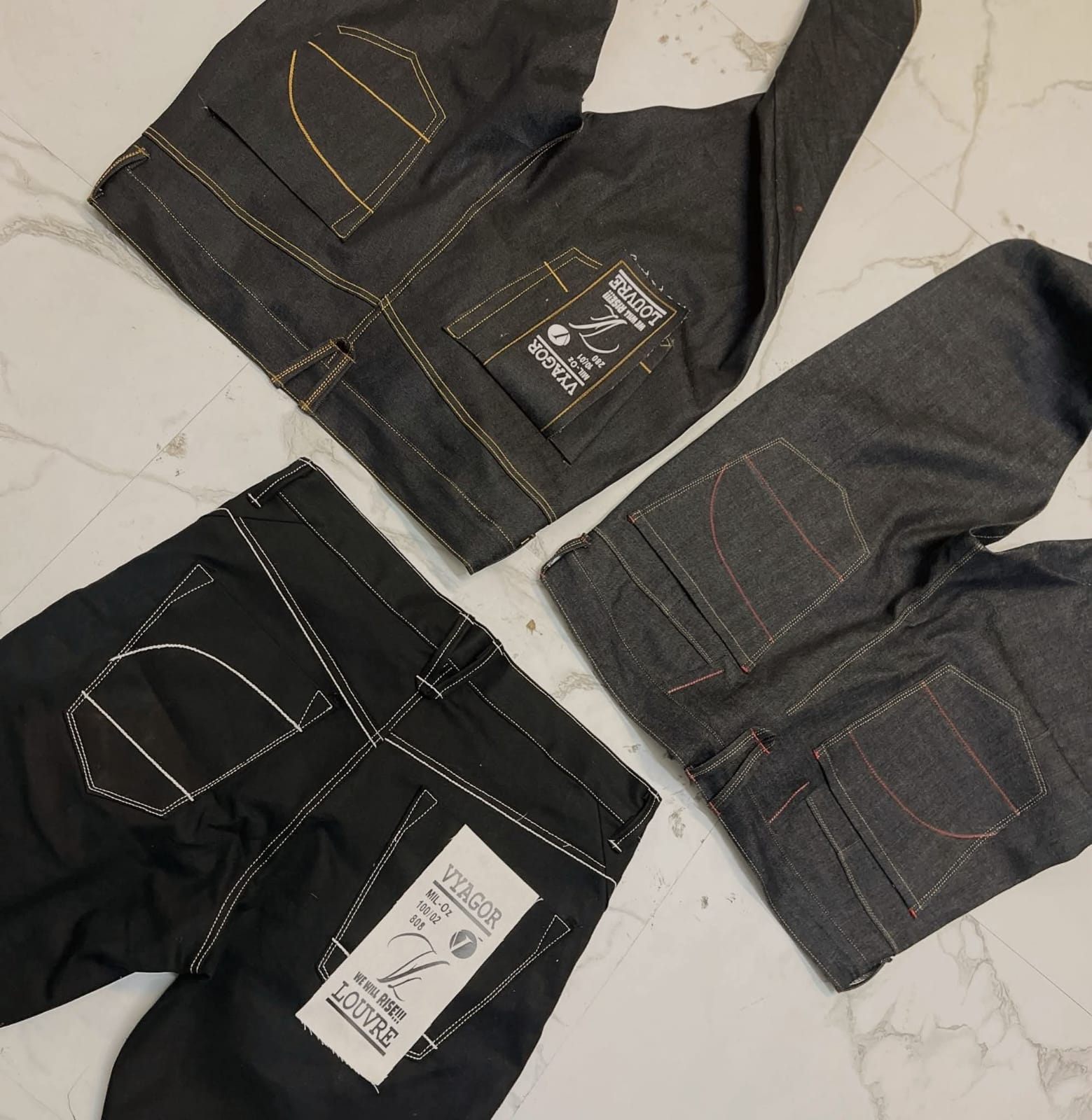 Three denim pieces showing distinctive construction and stitching